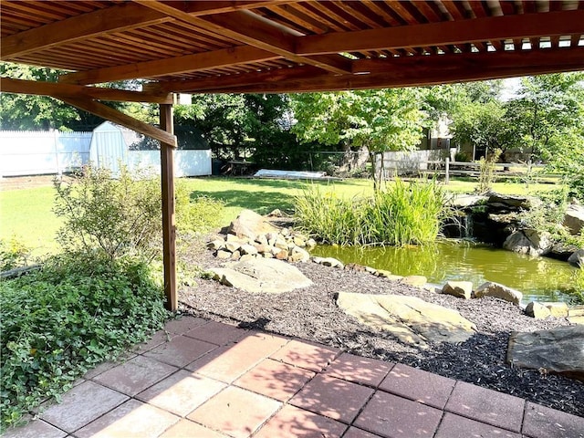 177 1150th St, Humboldt, KS 66748 - view of patio with a small pond and a storage shed