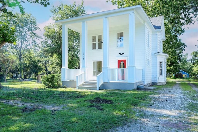 308 W Pine St, Cherokee, KS 66724 - neoclassical home featuring driveway and a front yard