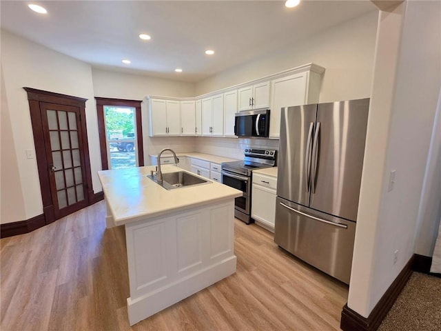 308 W Pine St, Cherokee, KS 66724 - kitchen featuring appliances with stainless steel finishes, light wood finished floors, white cabinets, recessed lighting, and light countertops