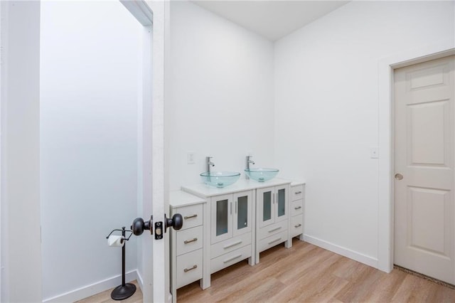 308 W Pine St, Cherokee, KS 66724 - bathroom with wood finished floors and double vanity