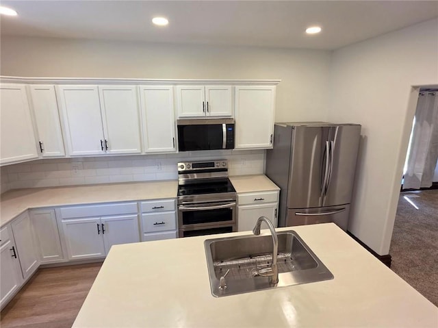 308 W Pine St, Cherokee, KS 66724 - kitchen featuring appliances with stainless steel finishes, white cabinetry, light countertops, recessed lighting, and tasteful backsplash