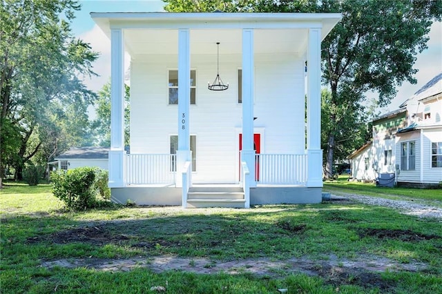 308 W Pine St, Cherokee, KS 66724 - view of front of home featuring covered porch and a front lawn