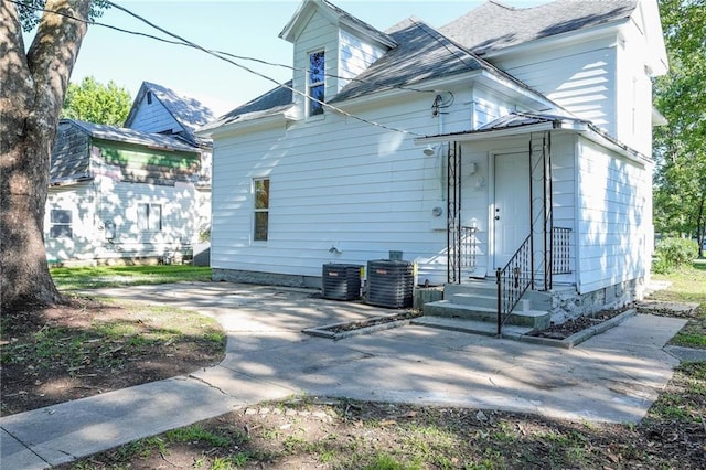 308 W Pine St, Cherokee, KS 66724 - rear view of house with a shingled roof, a patio, and entry steps