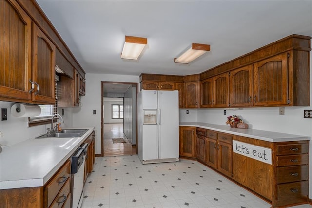 2334 N 100th Rd, Wellsville, KS 66092 - kitchen with white appliances, light flooring, light countertops, and brown cabinetry