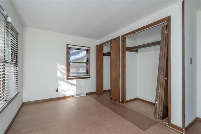 2334 N 100th Rd, Wellsville, KS 66092 - unfurnished bedroom featuring multiple closets and baseboards