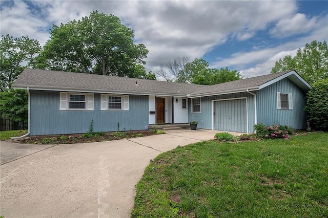 2439 Jasu Dr, Lawrence, KS 66046 - ranch-style home featuring an attached garage, driveway, a shingled roof, and a front yard