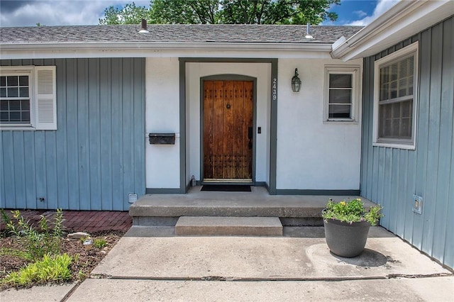2439 Jasu Dr, Lawrence, KS 66046 - view of exterior entry featuring roof with shingles and board and batten siding