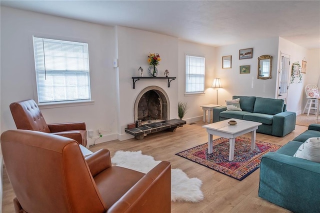 2439 Jasu Dr, Lawrence, KS 66046 - living area with a fireplace with raised hearth and wood finished floors