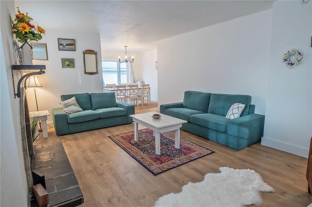 2439 Jasu Dr, Lawrence, KS 66046 - living area featuring a chandelier and wood finished floors