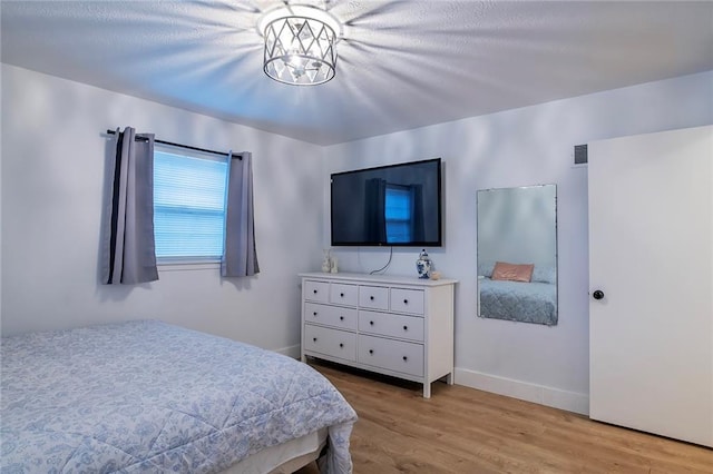 2439 Jasu Dr, Lawrence, KS 66046 - bedroom featuring light wood-style flooring and baseboards