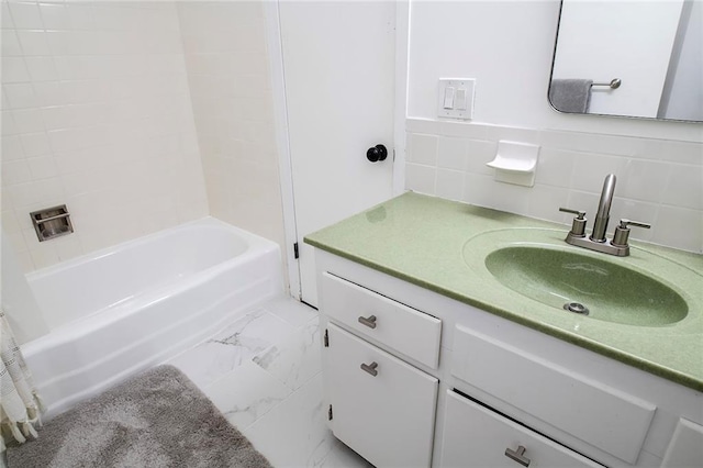 2439 Jasu Dr, Lawrence, KS 66046 - full bathroom with vanity, marble finish flooring, shower / bath combination, and tile walls