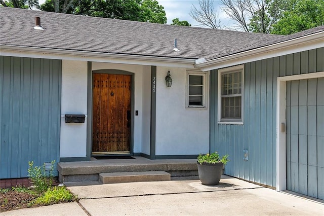 2439 Jasu Dr, Lawrence, KS 66046 - doorway to property featuring a shingled roof and board and batten siding