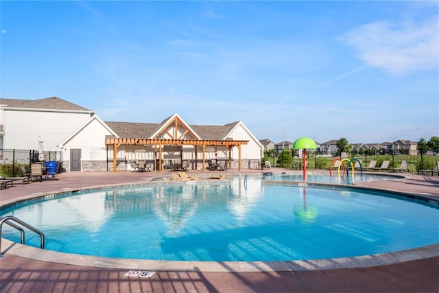 18841 W 169th Ter, Olathe, KS 66062 - community pool with a patio, a pergola, and a water play area