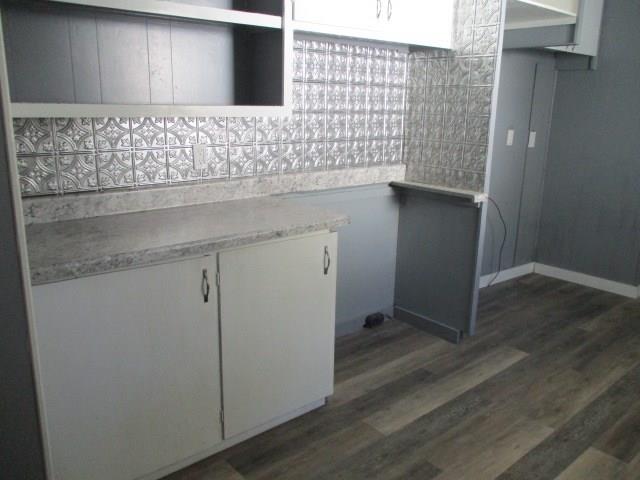 kitchen featuring dark wood-type flooring and white cabinets