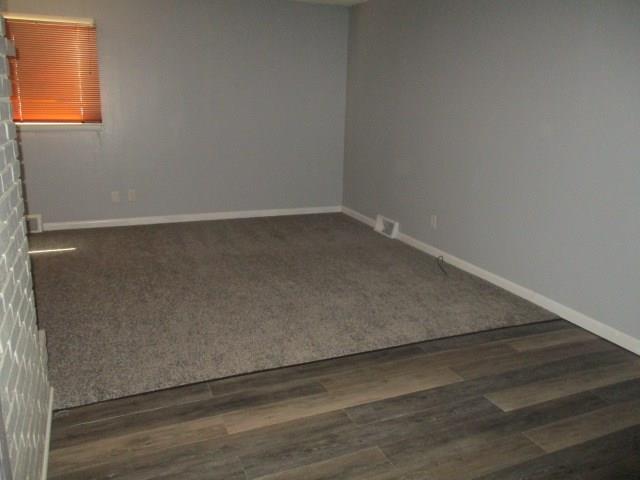 unfurnished room featuring dark hardwood / wood-style floors