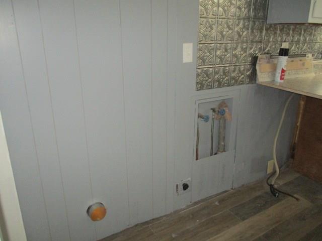 washroom with hardwood / wood-style flooring and hookup for an electric dryer