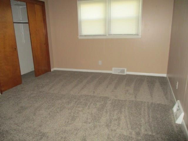 unfurnished bedroom with carpet flooring