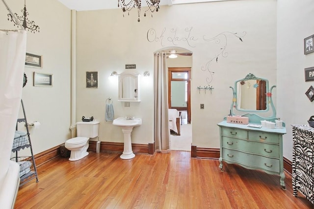 bathroom featuring hardwood / wood-style flooring and toilet