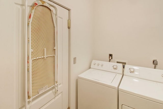 laundry area with hookup for an electric dryer, hookup for a washing machine, and washer and clothes dryer