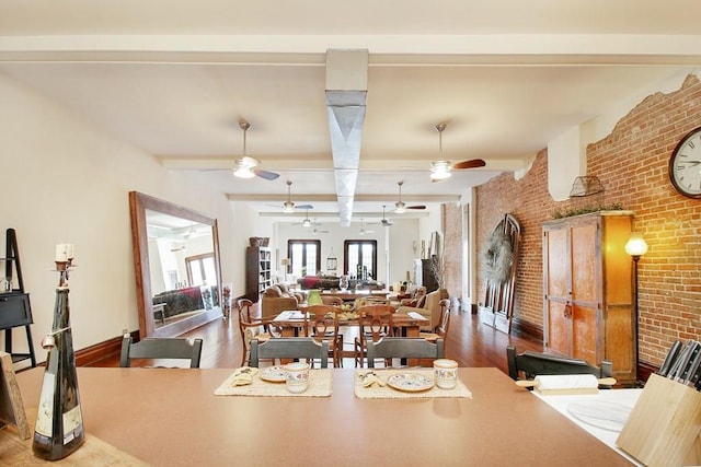 dining room with ceiling fan, brick wall, and wood-type flooring