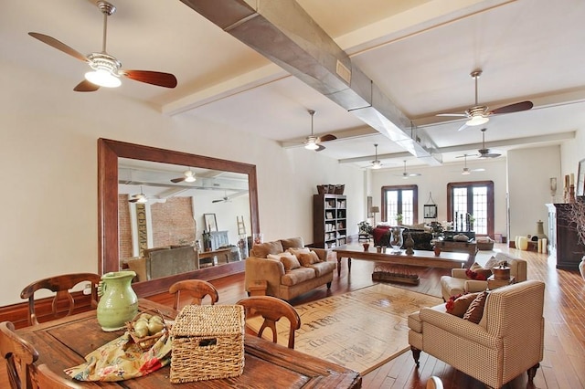 living room with beam ceiling, hardwood / wood-style floors, and ceiling fan