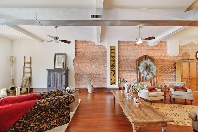 living room featuring brick wall, beam ceiling, dark hardwood / wood-style floors, and ceiling fan