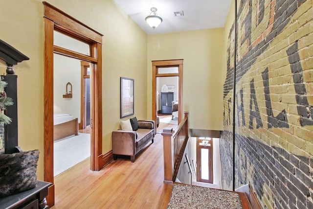 entrance foyer with brick wall and wood-type flooring