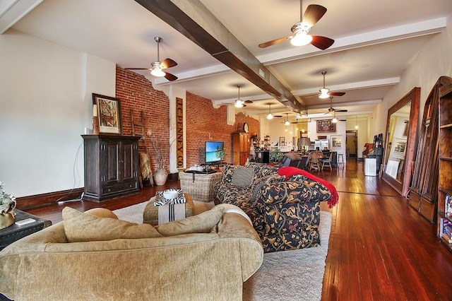 living room with ceiling fan, beam ceiling, hardwood / wood-style floors, and brick wall