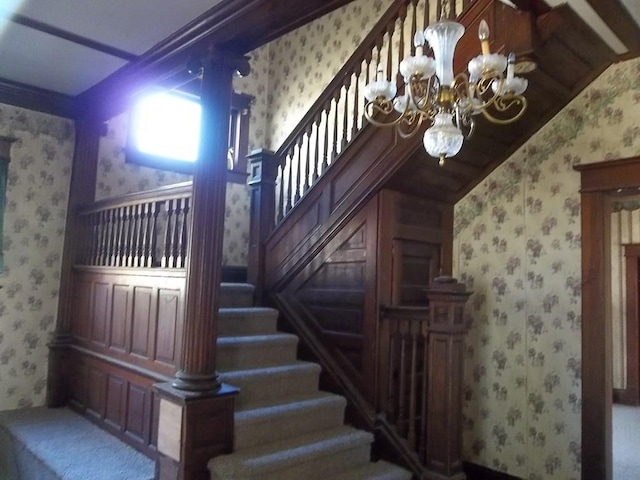 stairs featuring a notable chandelier and vaulted ceiling