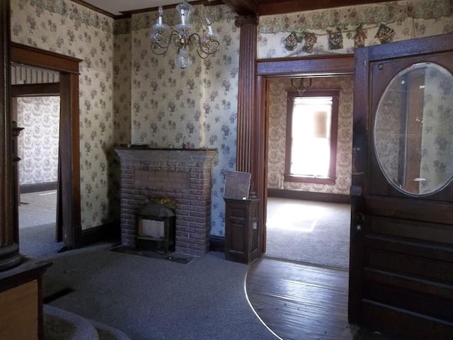 carpeted living room featuring ornate columns and crown molding