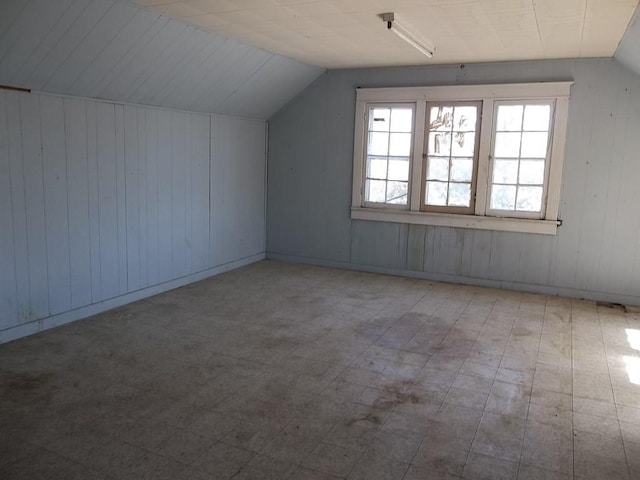 bonus room featuring tile flooring and lofted ceiling