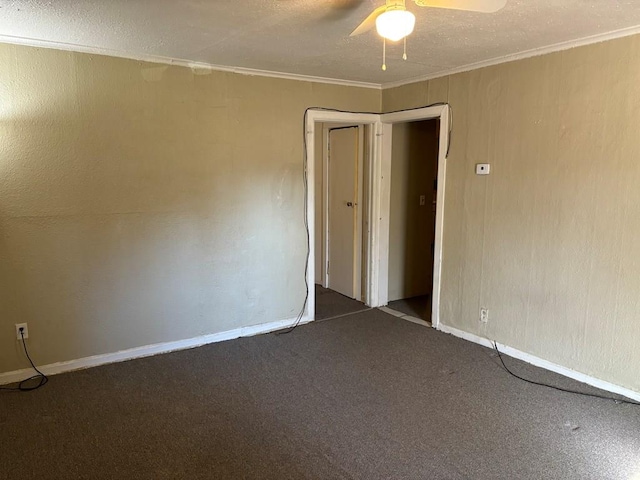 carpeted spare room with ceiling fan, ornamental molding, and a textured ceiling