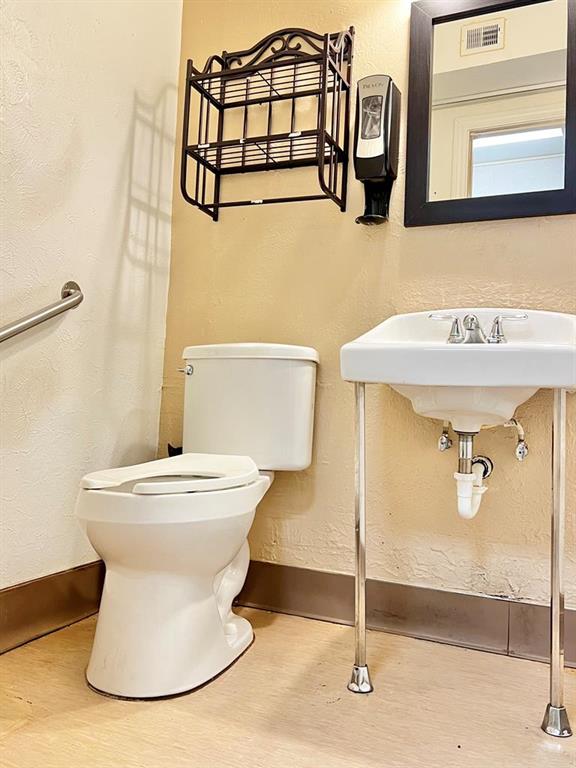 bathroom featuring hardwood / wood-style floors and toilet