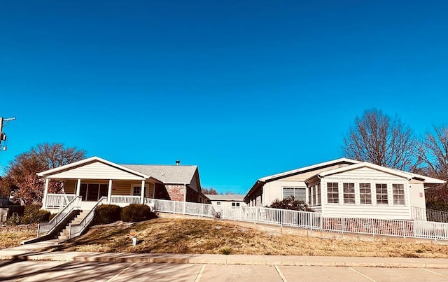 single story home with a porch