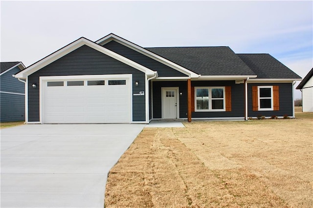 view of front of property with a porch and a garage