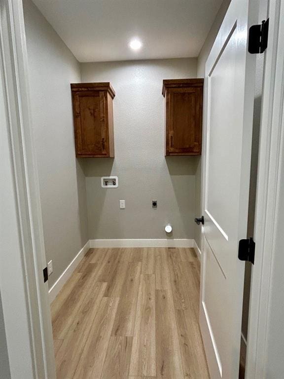 laundry room with hookup for an electric dryer, cabinets, washer hookup, and light hardwood / wood-style floors