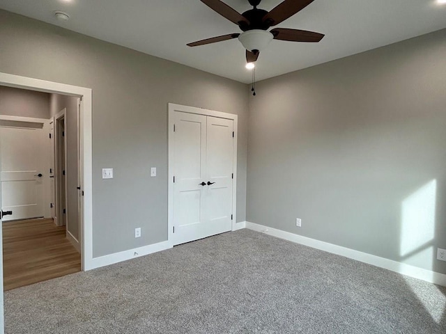 unfurnished bedroom with carpet flooring, a closet, and ceiling fan