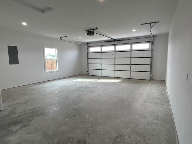 garage featuring electric panel and a garage door opener