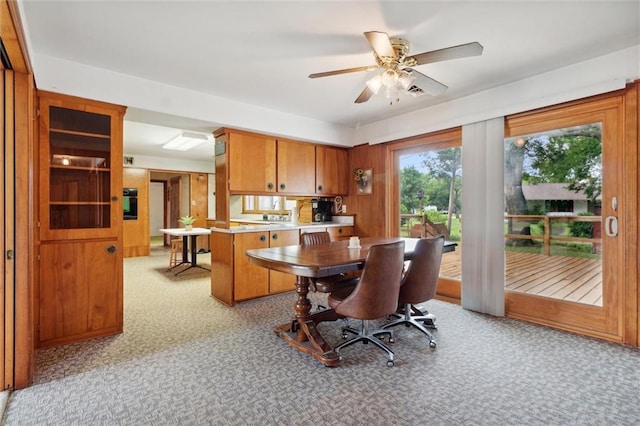 interior space featuring ceiling fan and light carpet