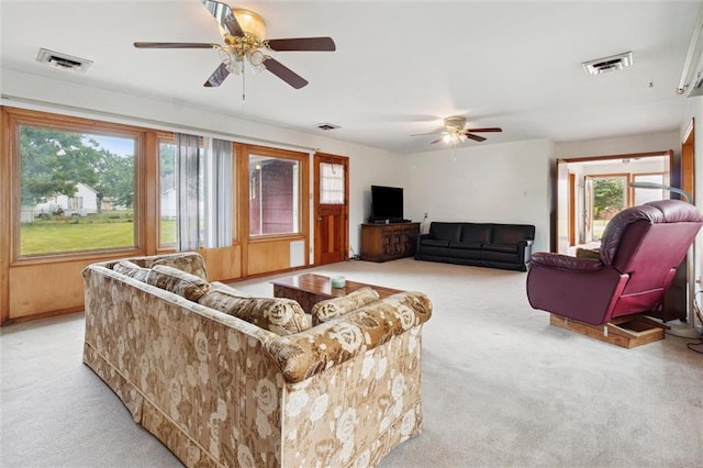 living room with light colored carpet and ceiling fan