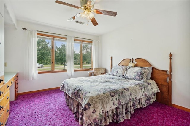 bedroom featuring dark carpet and ceiling fan