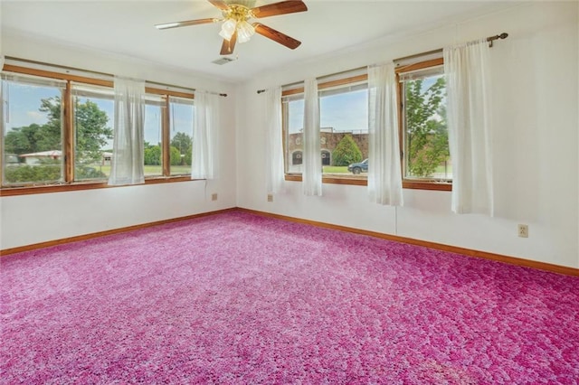 empty room with a healthy amount of sunlight, carpet flooring, and ceiling fan