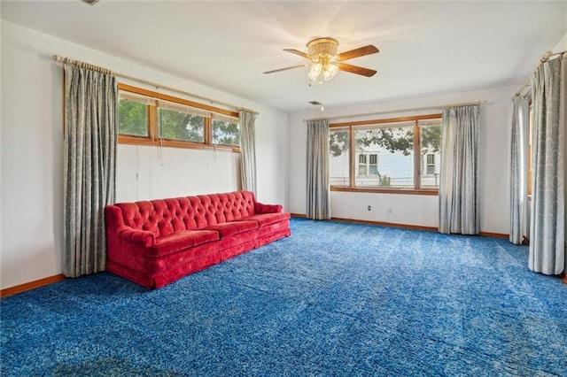 unfurnished room featuring ceiling fan and carpet