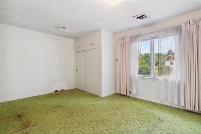 unfurnished bedroom with carpet and a closet