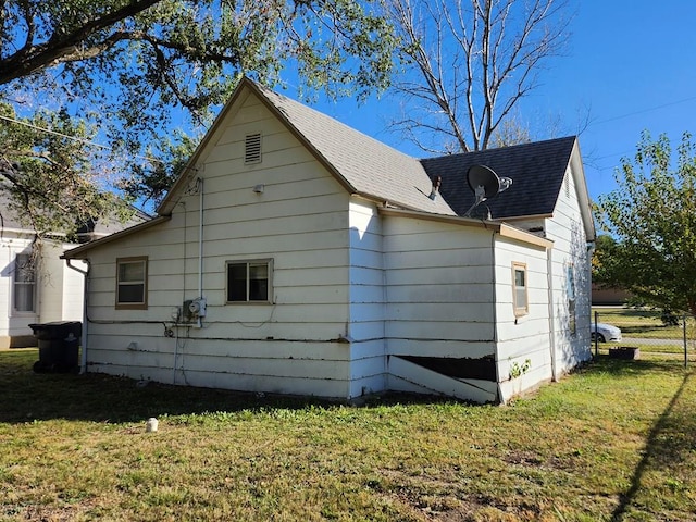 view of side of property with a yard