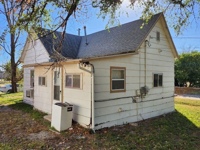 back of property featuring a lawn