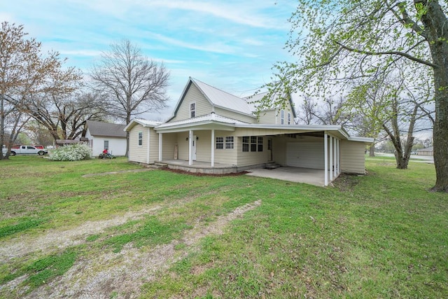 rear view of property with a lawn, a porch, and a carport