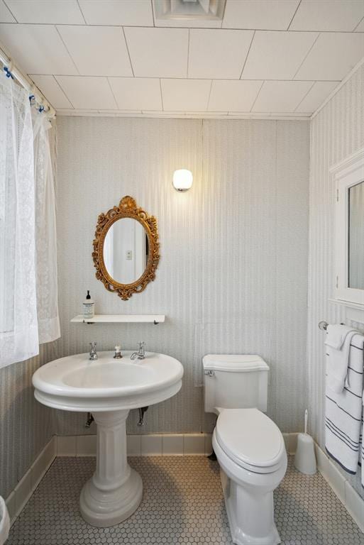 bathroom featuring tile patterned flooring and toilet