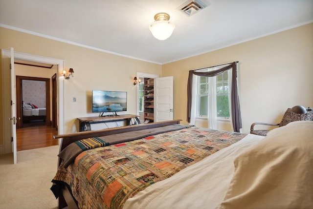 bedroom with crown molding and carpet