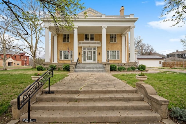 greek revival house featuring a front lawn